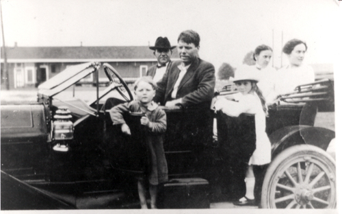 Bobby Dunbar (behind car door) with unknown persons